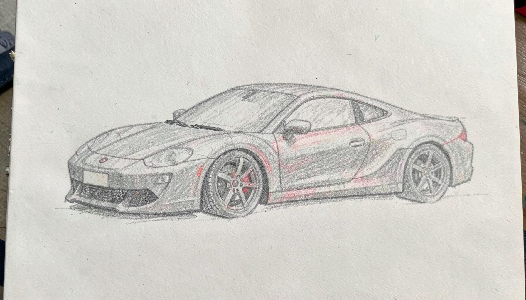 Soft graphite pencil sketch of a low-slung sports car silhouette in cool grey tones on an off-white page